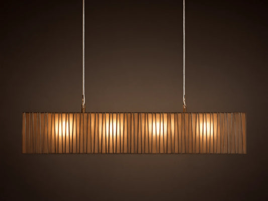 Horizontal Jeunet Rectangular Chandelier in Nickel, hanging against a tan wall, showing glowing white panels through vertical nickel bars.