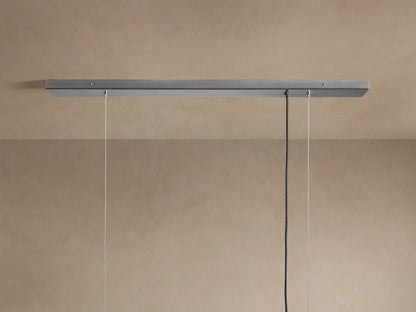 Close-up of a rectangular Jeunet Chandelier in nickel, featuring vertical frosted glass panels glowing softly from within, hanging.