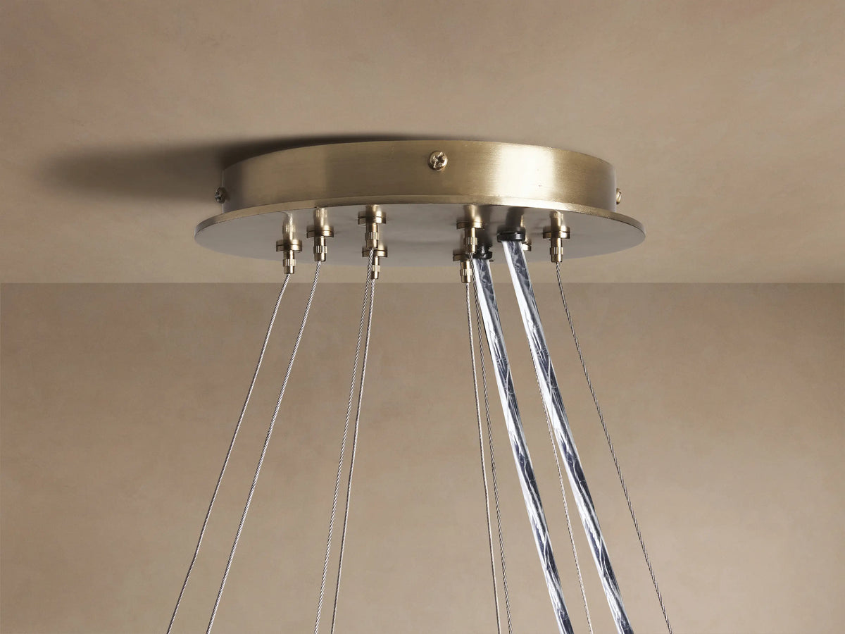 Close-up of Jeunet 2-Tier Round Chandelier, antiqued brass frame, illuminated white and clear rectangular glass panels.