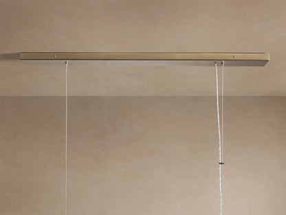 Jeunet Rectangular Chandelier with antiqued brass frame and glowing, textured glass panels, angled view.