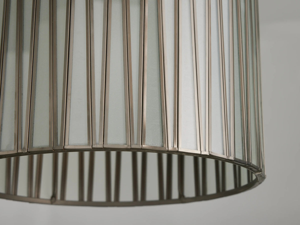 Pendant light with cylindrical glass and iron shade, antiqued brass finish. Vertical iron lines over clear glass, hanging by cord.