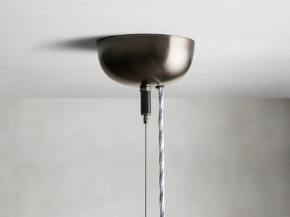 Jeunet Pendant with glass and iron frame in an antiqued brass or nickel finish, showcasing vertical lines against a neutral background.