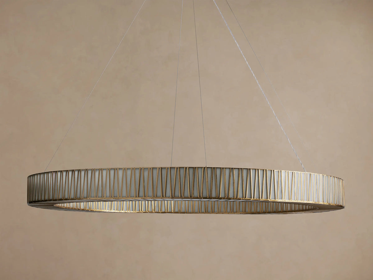 Jeunet Round Chandelier. Large, round antiqued brass chandelier with vertical glass panels, illuminated, hanging from cables.