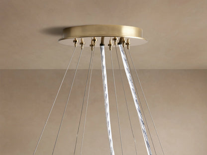 Close-up of Jeunet 2-Tier Round Chandelier with antiqued brass frames and illuminated translucent panels, casting warm light.