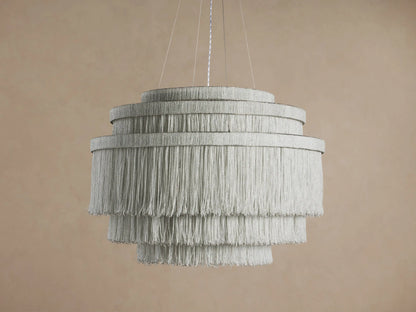 Romilly Tiered Chandelier, 4-tier circular design, light gray glass bead fringe glowing brightly, hanging against a neutral wall.