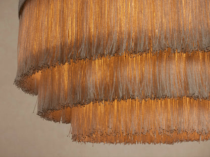 Romilly Tiered Chandelier, light grey, with four graduated tiers of delicate, shimmering glass bead fringe, hanging.