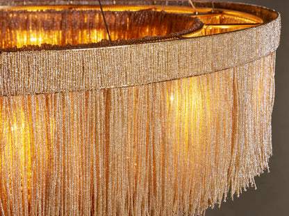Close-up of Romilly Round Chandelier with golden glass beads forming a fringed shade, glowing warmly from within.