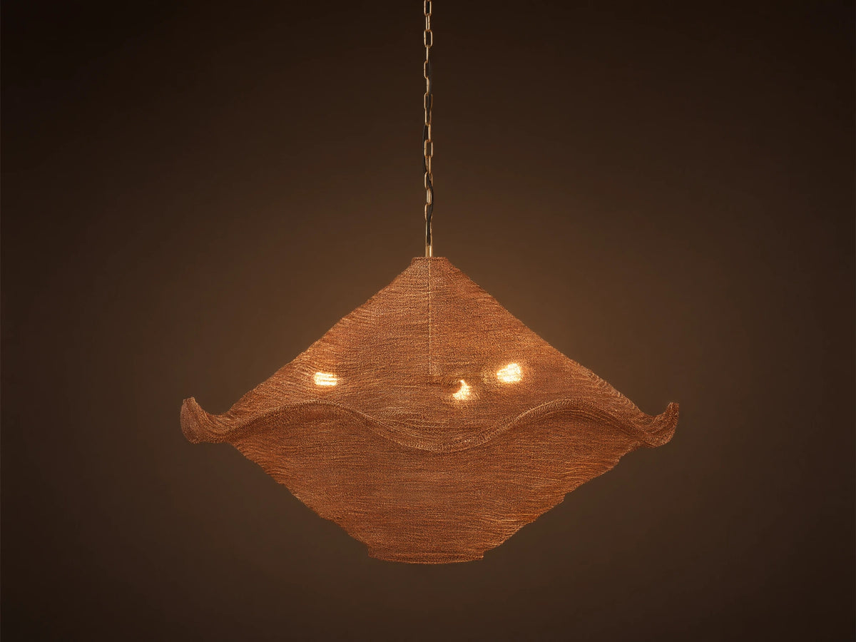 Mirza Sphere Chandelier. Draped woven antique brass mesh in a square shape with wavy edges, 3 glowing bulbs inside, hanging.