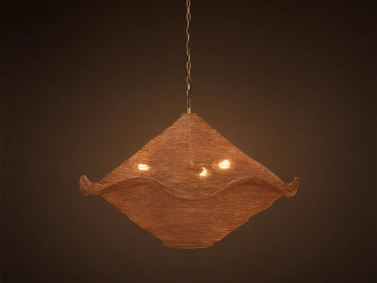 Mirza Sphere Chandelier. Draped woven antique brass mesh in a square shape with wavy edges, 3 glowing bulbs inside, hanging.