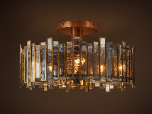 Laila Flush Mount with antique copper canopy, surrounded by rectangular antiqued mirrored-glass panes in a brass frame, lights glowing.