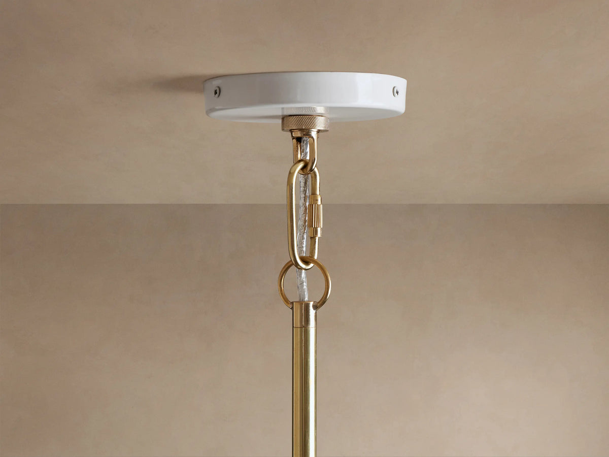 Bonham Pendant close-up: white canopy, shining brass interior with two glowing E12 filament bulbs, viewed from below.