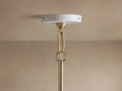 Bonham Pendant close-up: white canopy, shining brass interior with two glowing E12 filament bulbs, viewed from below.