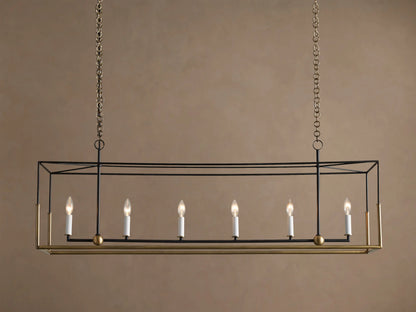 Holt Linear Chandelier. Black rectangular frame with antique brass base, hanging from chains. Six illuminated candle-style bulbs.