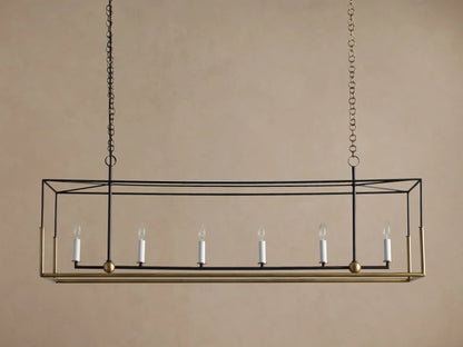 Holt Linear Chandelier. Black rectangular frame with antique brass base, hanging from chains. Six illuminated candle-style bulbs.