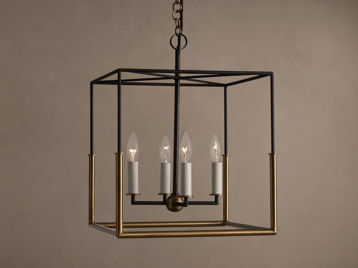 Holt Square Pendant, a square, open-cage light fixture with black and antiqued brass frames, featuring four clear candle-style bulbs.