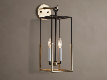 Holt Sconce: rectangular lantern-style light with black iron and antiqued brass frame, two lit candle-style bulbs on neutral wall.