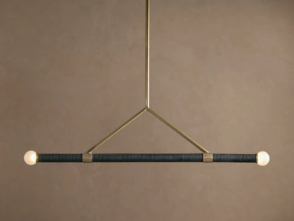 Randall Leather Pendant: Dark leather-wrapped horizontal bar with two frosted globe bulbs, suspended by a burnished brass frame.