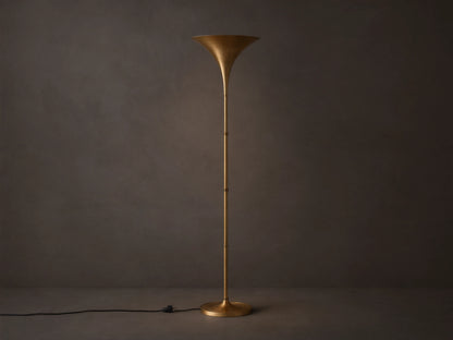 Tall Tultz Floor Lamp with burnished brass finish, tulip-shaped shade, slender pole, and round base on wooden floor.