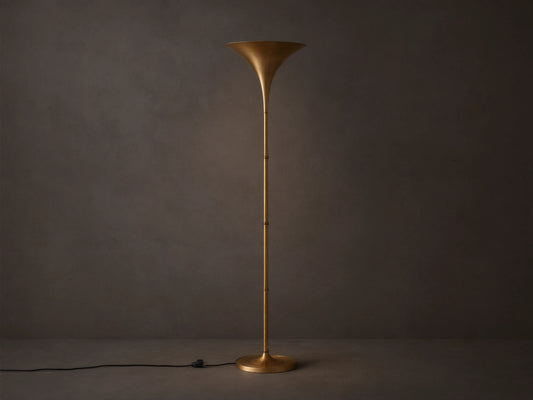 Tall Tultz Floor Lamp with burnished brass finish, tulip-shaped shade, slender pole, and round base on wooden floor.