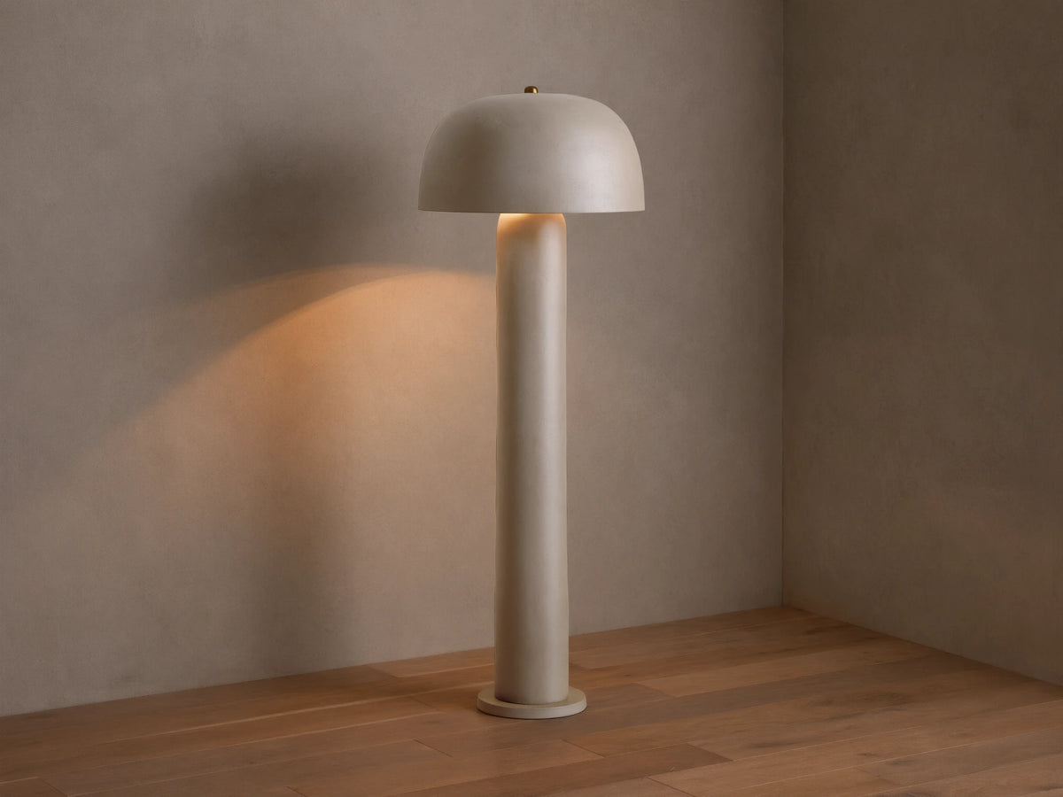 Front view of the beige Mushroom Floor Lamp with cylindrical body and dome shade, emitting warm light.