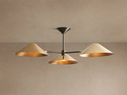 Simms Flush Mount with three polished brass cone shades on an antiqued bronze central rod, mounted on a beige ceiling.