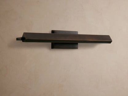 Zaeden Picture Light: Bronze-plated iron horizontal bar light mounted on a neutral wall, highlighting its metallic finish.