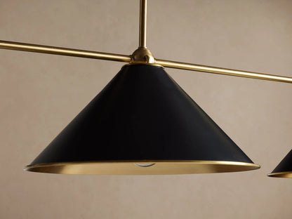 Arno Linear Chandelier with three black conical shades, polished brass interiors, and a brass rod, hanging.