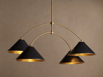 Arno Round Chandelier with a gold brass frame and four matte black conical shades, each with a polished brass interior, hanging.