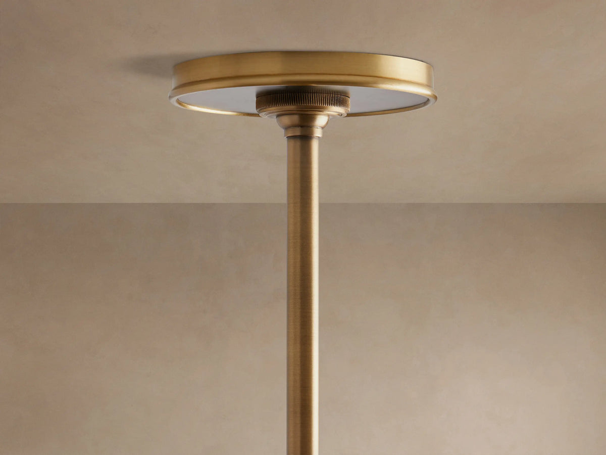 Arno Round Chandelier with a brass frame and four matte black cone shades, showing polished brass interiors.