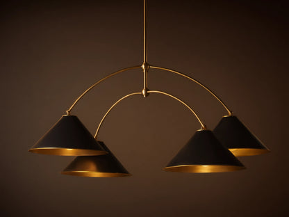 Arno Round Chandelier with a gold brass frame and four matte black conical shades, each with a polished brass interior, hanging.