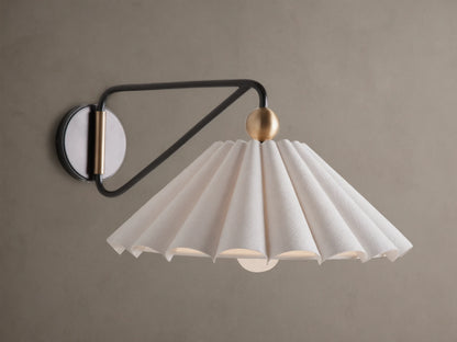 Illuminated Haylen Sconce: black metal arm, circular backplate with antique brass, pleated cream fabric shade.