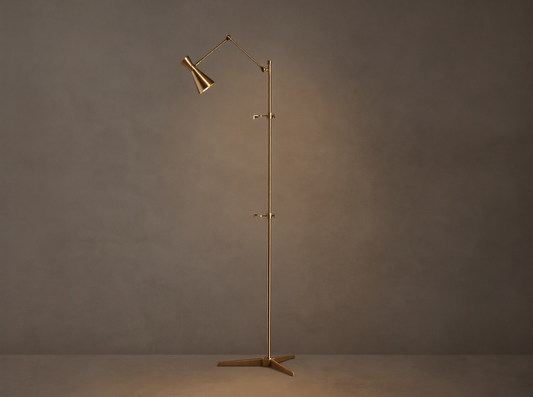 Tall, slender gold brass Jaxtyn Easel Floor Lamp with an angled light head, X-base, and small art display hooks.