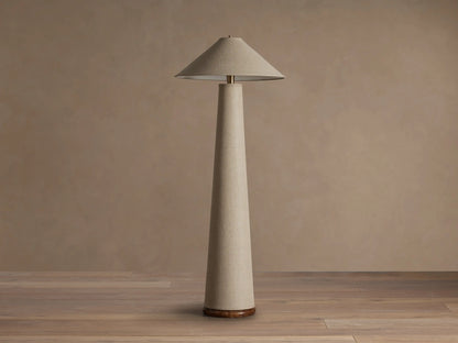 Ombra Floor Lamp with light beige linen conical shade and tall column body, teak wood base, and antiqued brass detail.