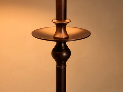 Close-up of the antique bronze Winslow Table Lamp, detailing its stem with a flat disc and a decorative spherical section.