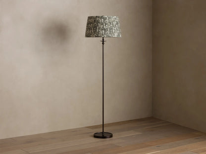 Full view of Winslow Floor Lamp featuring a bronze finish and pleated patterned fabric shade, illuminated.