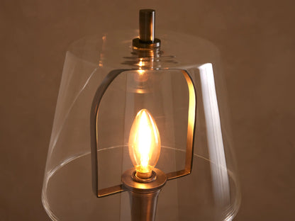 Candice Floor Lamp with dark pewter finish, round base, clear bell-shaped glass shade, and a glowing filament bulb.