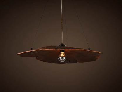 Arruga Chandelier: Dark brown, organic milpa wood dome, suspended by black cables, with a softly glowing bulb.