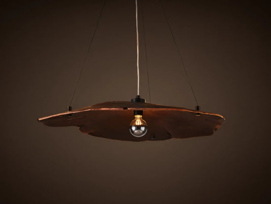 Arruga Chandelier: Dark brown, organic milpa wood dome, suspended by black cables, with a softly glowing bulb.
