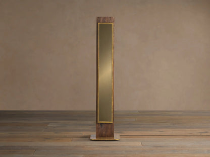 Vigas Floor Lamp: Tall wooden lamp with brass trim, illuminated mirrored glass revealing a textured interior, standing on wood floor.