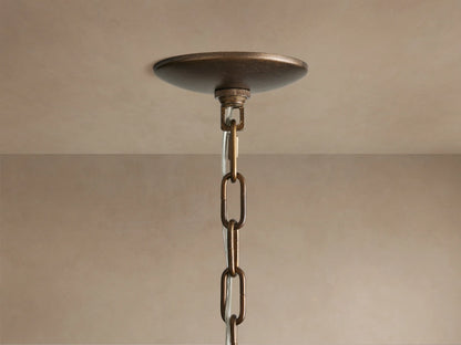 Close-up Paloma Chandelier with tiered, handwoven brown rattan shade, showcasing intricate texture against a light background.