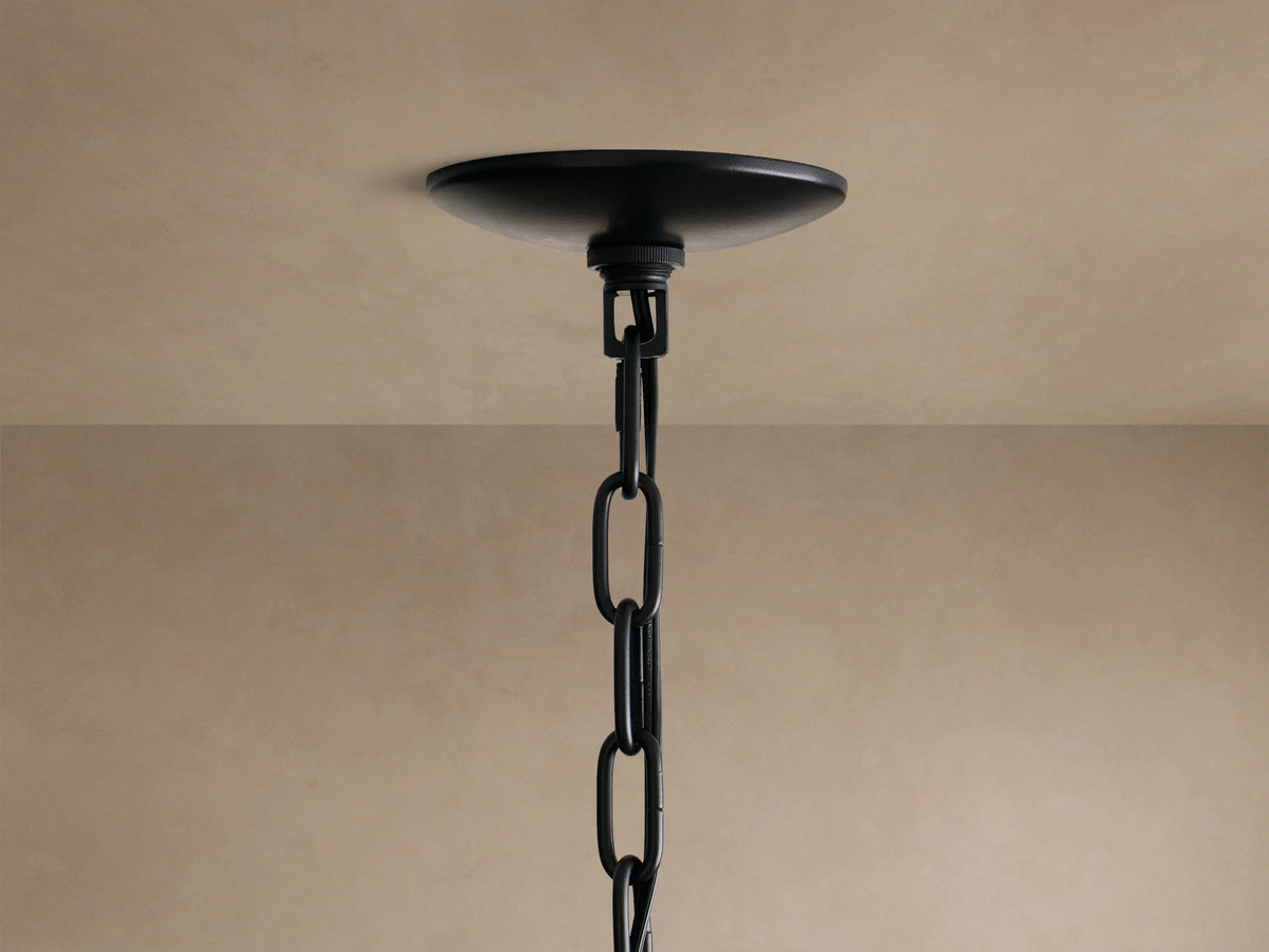 Close-up of the Paloma Chandelier's black, handwoven rattan shade, featuring a tiered design and intricate texture.