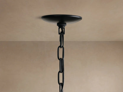 Close-up of the Paloma Chandelier's black, handwoven rattan shade, featuring a tiered design and intricate texture.