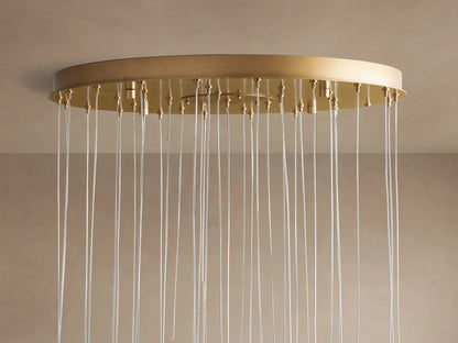 Arica Round Chandelier: circular gold canopy mounted to a beige ceiling, with many clear airplane cables hanging down.