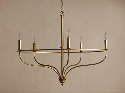Brass Rosalind Chandelier with five lit candle-style bulbs on a thin circular frame, hanging against a neutral background.