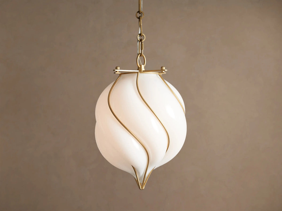 Margolis Small Pendant: White hand-blown glass shade with swirling brass-finished iron bands, hanging from a chain.