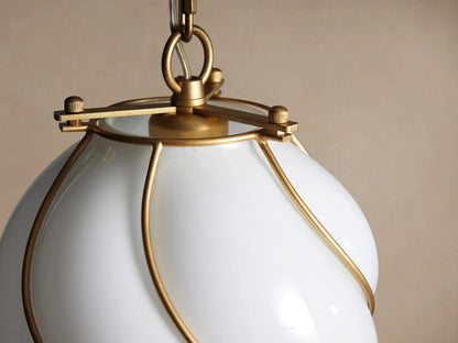 Margolis Small Pendant: White hand-blown glass with a twisted, bulbous form, wrapped in a brass spiral frame, hanging from a chain.