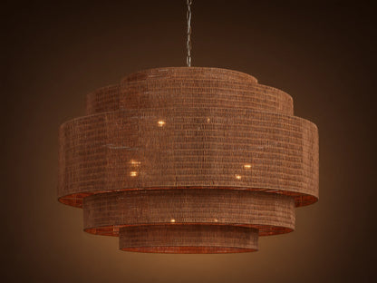 Paloma 52" tiered brown woven rattan chandelier hangs from a chain, with warm light glowing from within its shades.