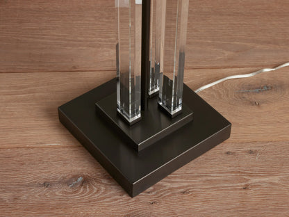 Dawson Floor Lamp with a sleek crystal and iron base, rectangular white shade on top, standing on wooden floor.