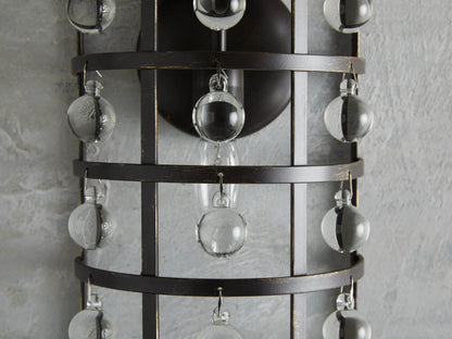 La Cage Sconce with iron cage frame, antiqued metallic finish, and hanging Italian crystal spheres, mounted on wall.