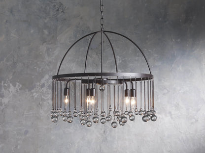 A round chandelier made of solid iron with five exposed bulbs and hanging glass accents, suspended by an iron chain.